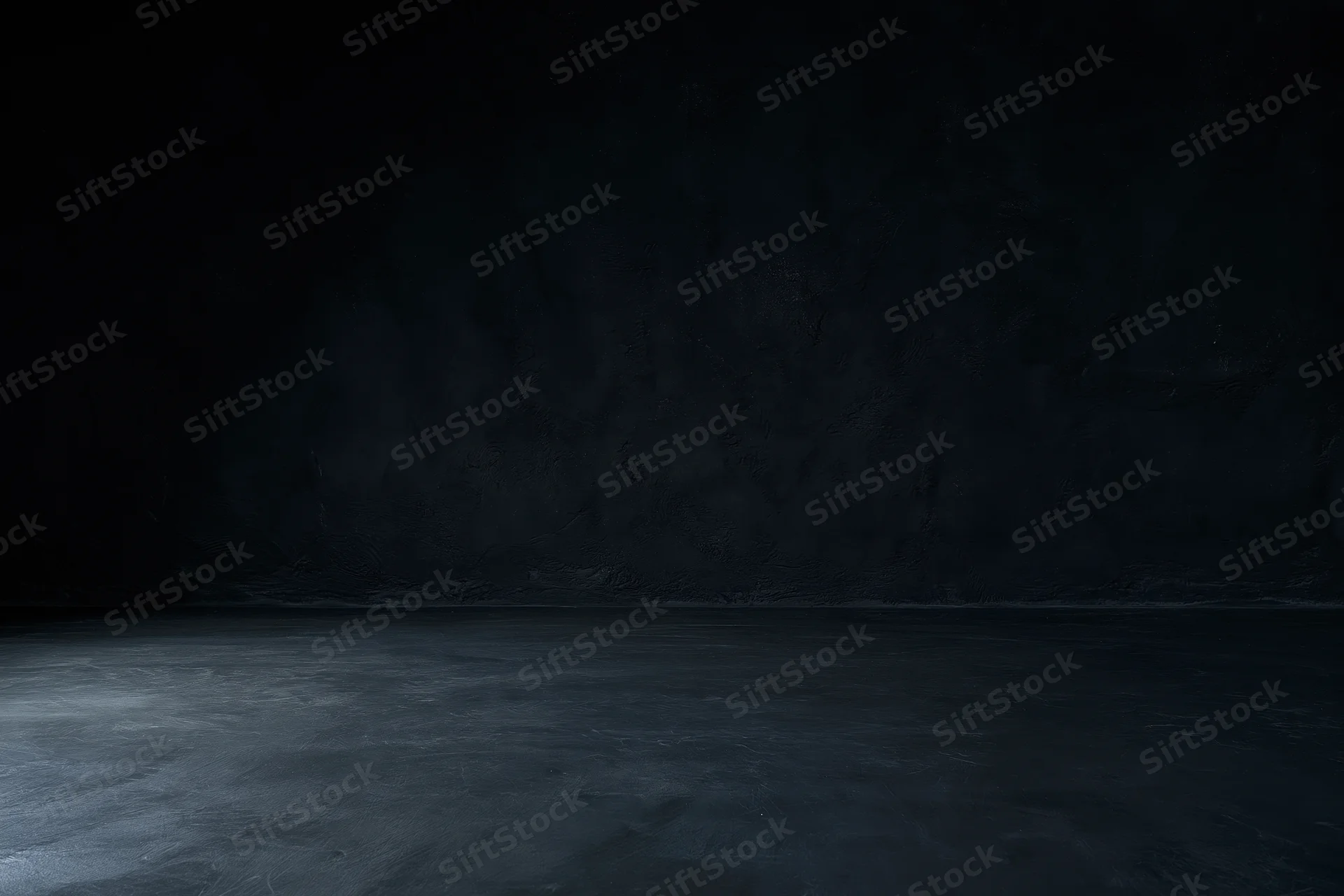 Dark empty room with textured concrete wall and floor