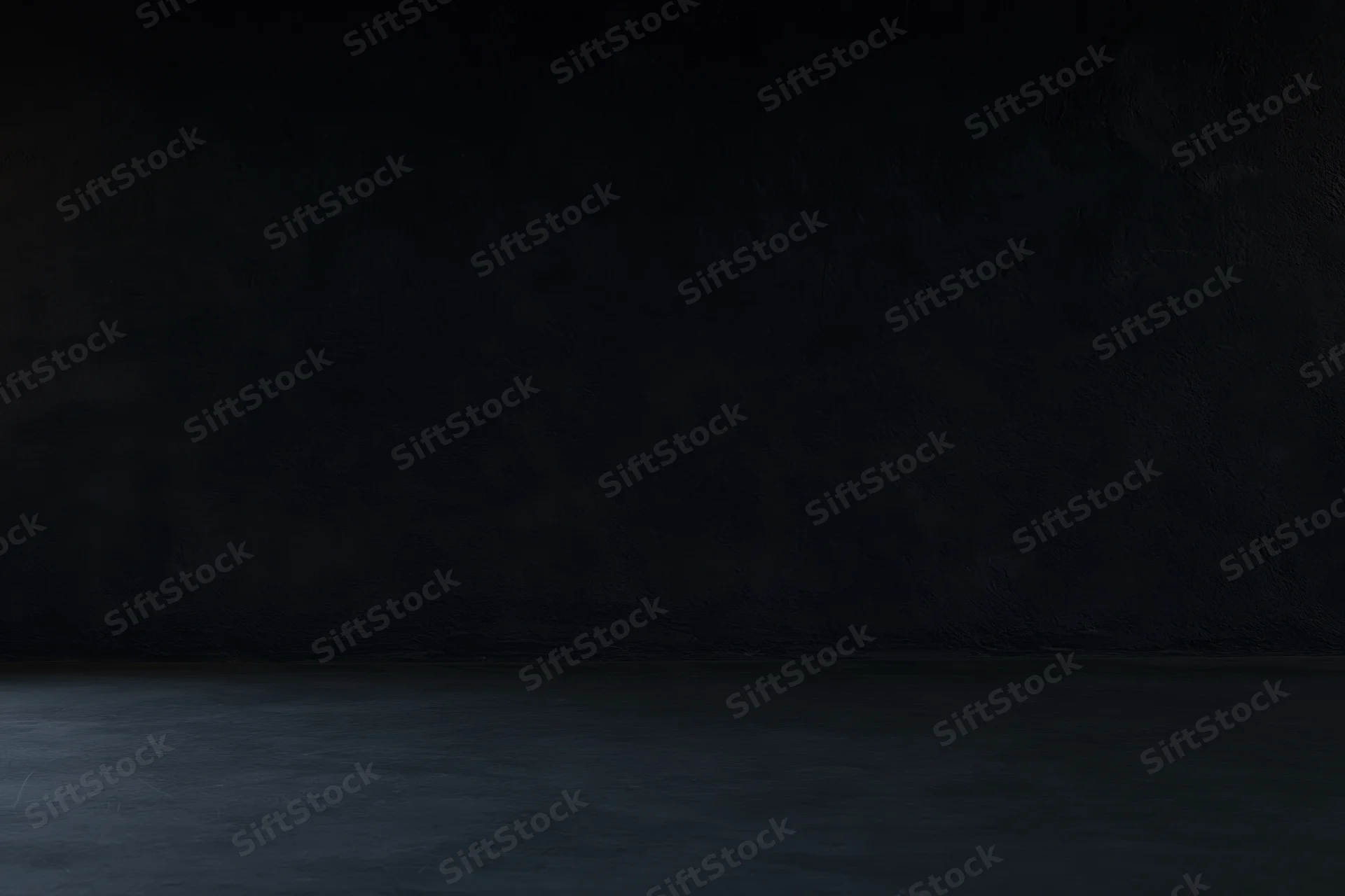 Dark empty room with textured concrete wall and floor