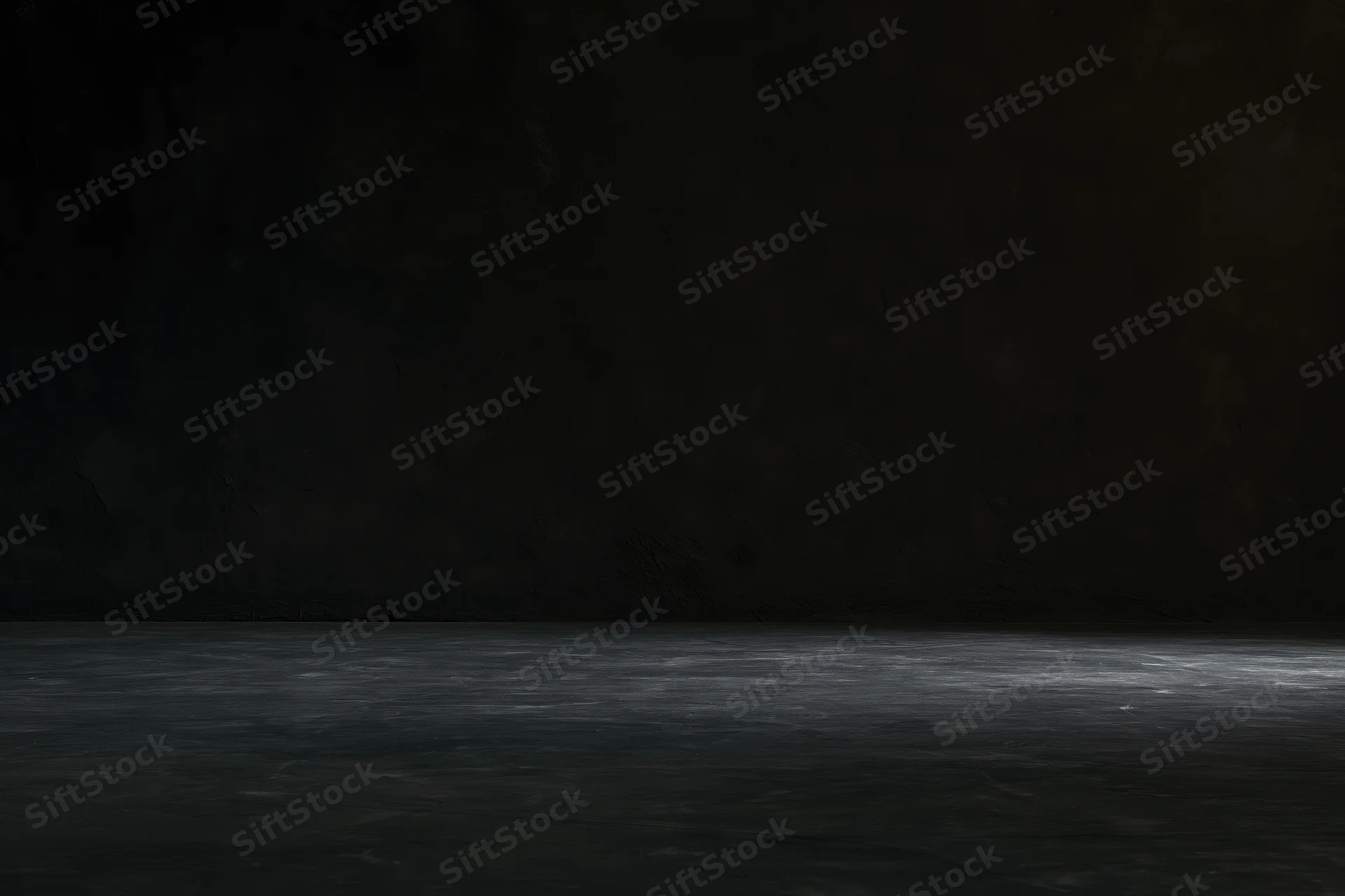 Dark empty room with rough concrete wall and floor