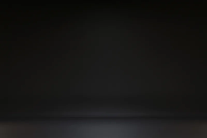Seamless black studio backdrop with gradient lighting and empty floor space