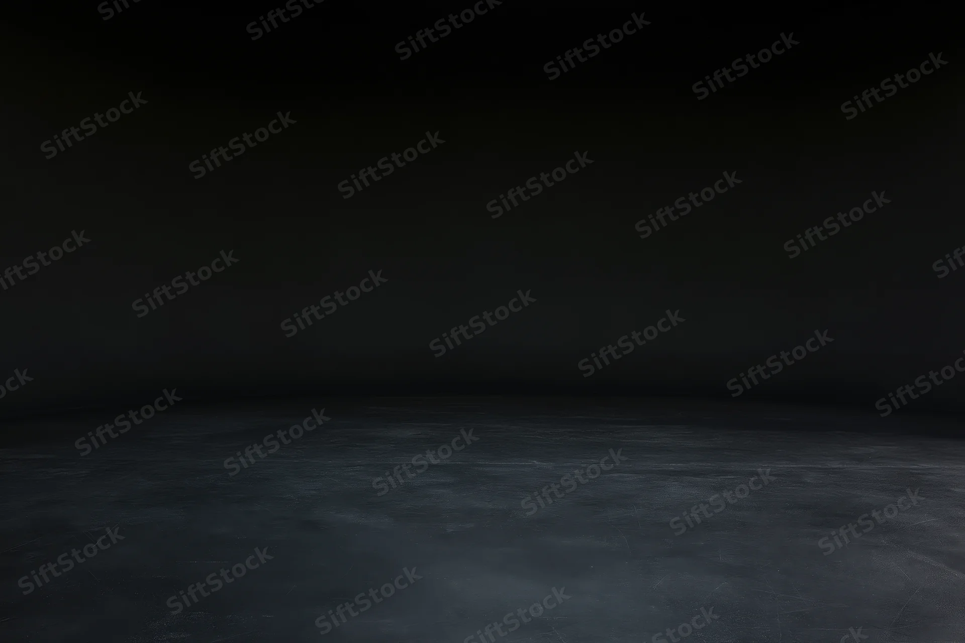 Dark studio interior with seamless black wall meeting floor