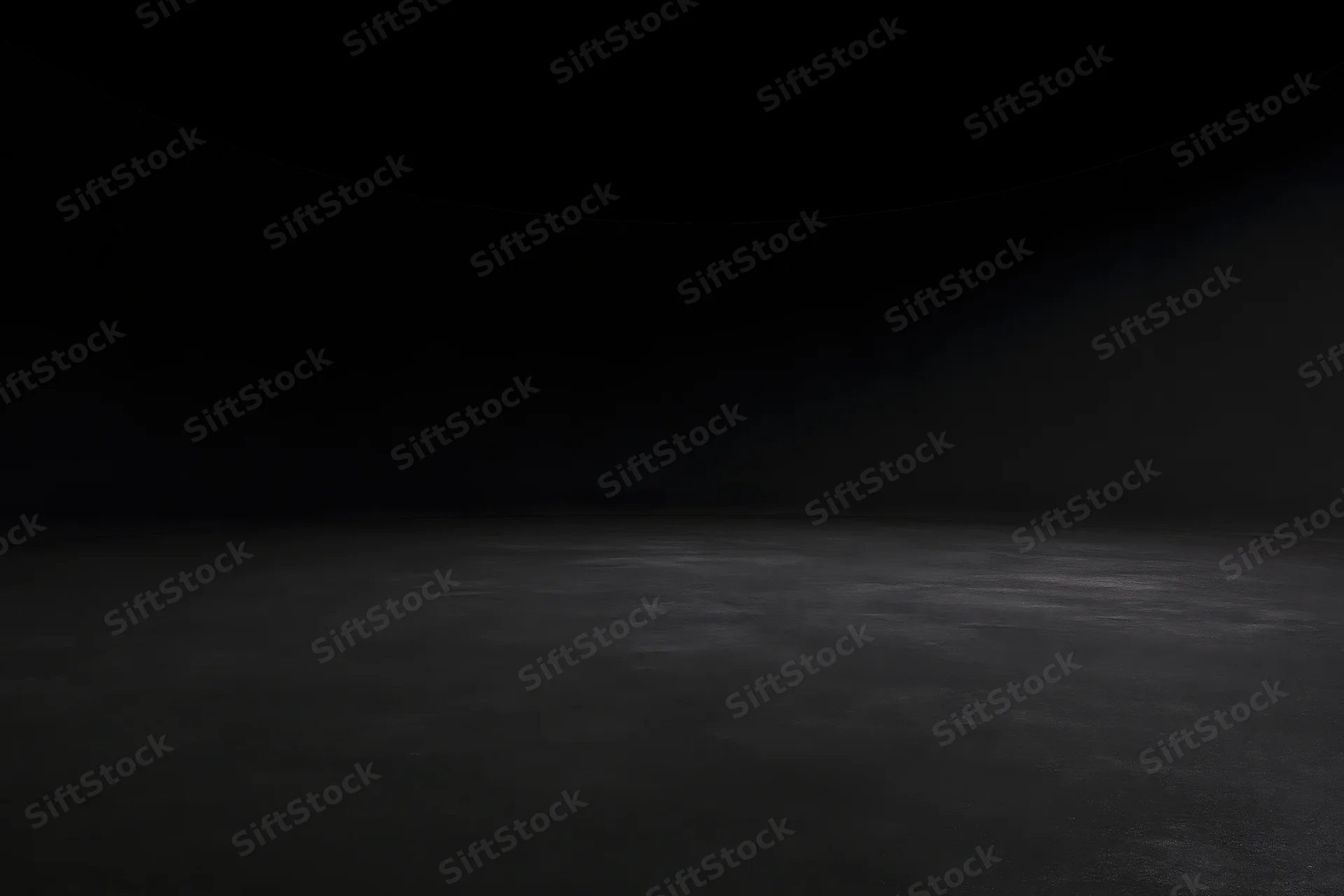 Dark studio interior with seamless black wall meeting floor