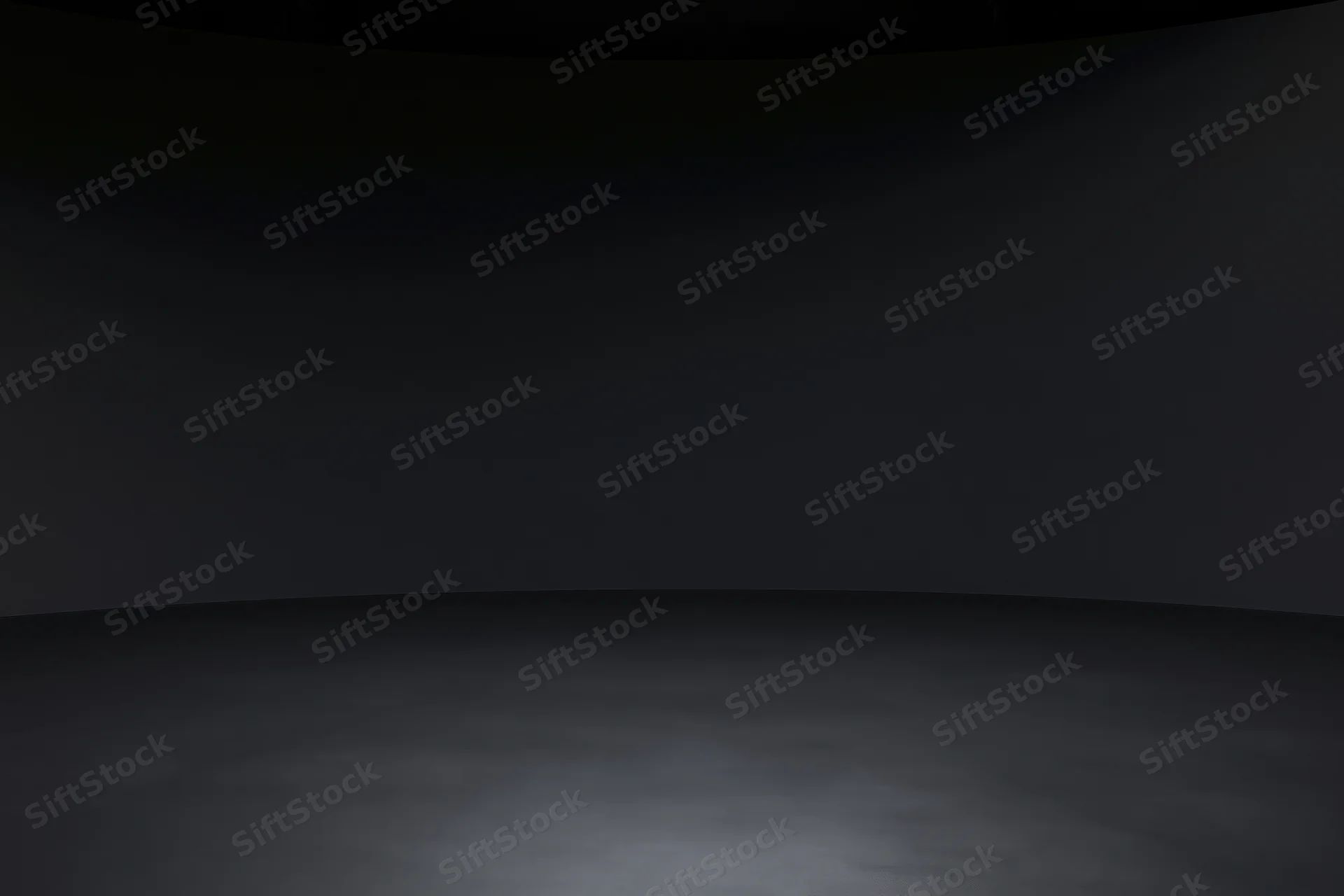 Dark studio interior with seamless black wall meeting floor