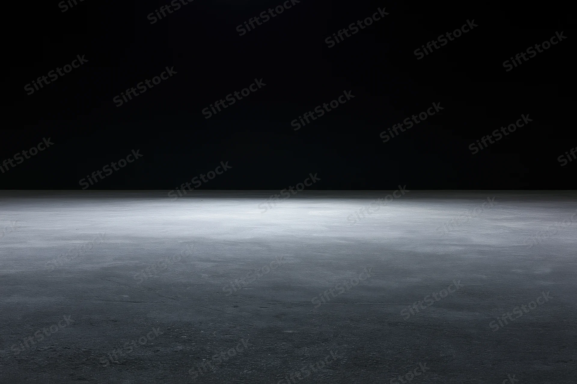 Dark studio interior with spotlight on concrete floor, empty space for display