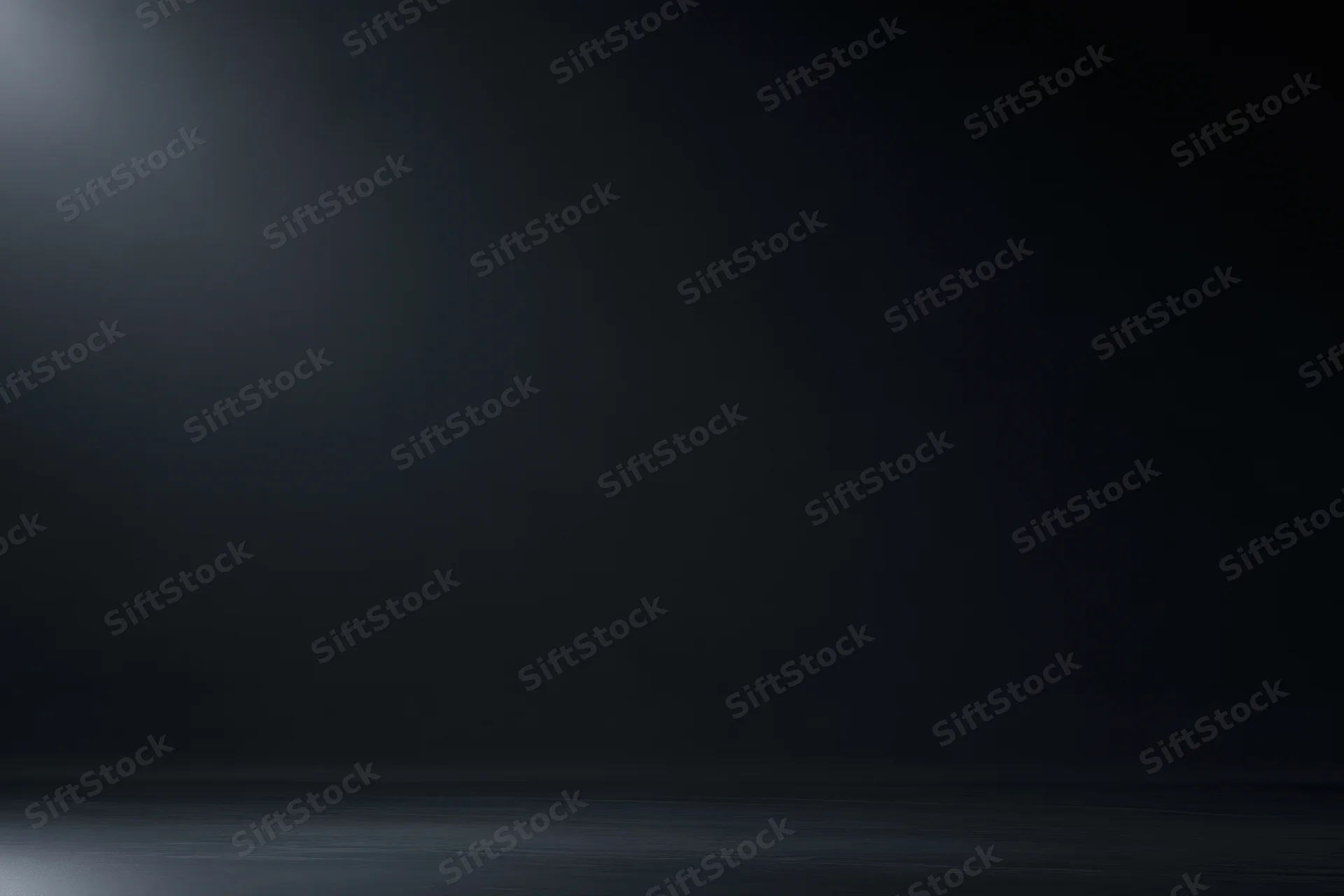 Dark studio backdrop with soft gradient lighting and empty floor space