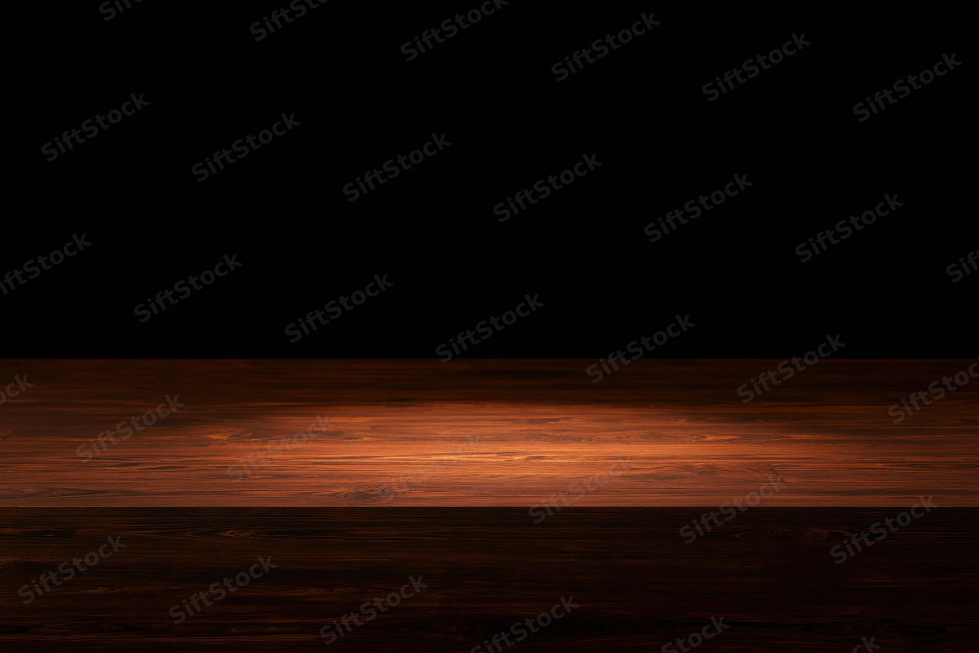 Dark wooden surface illuminated by a single spotlight with warm glow and shadowed edges
