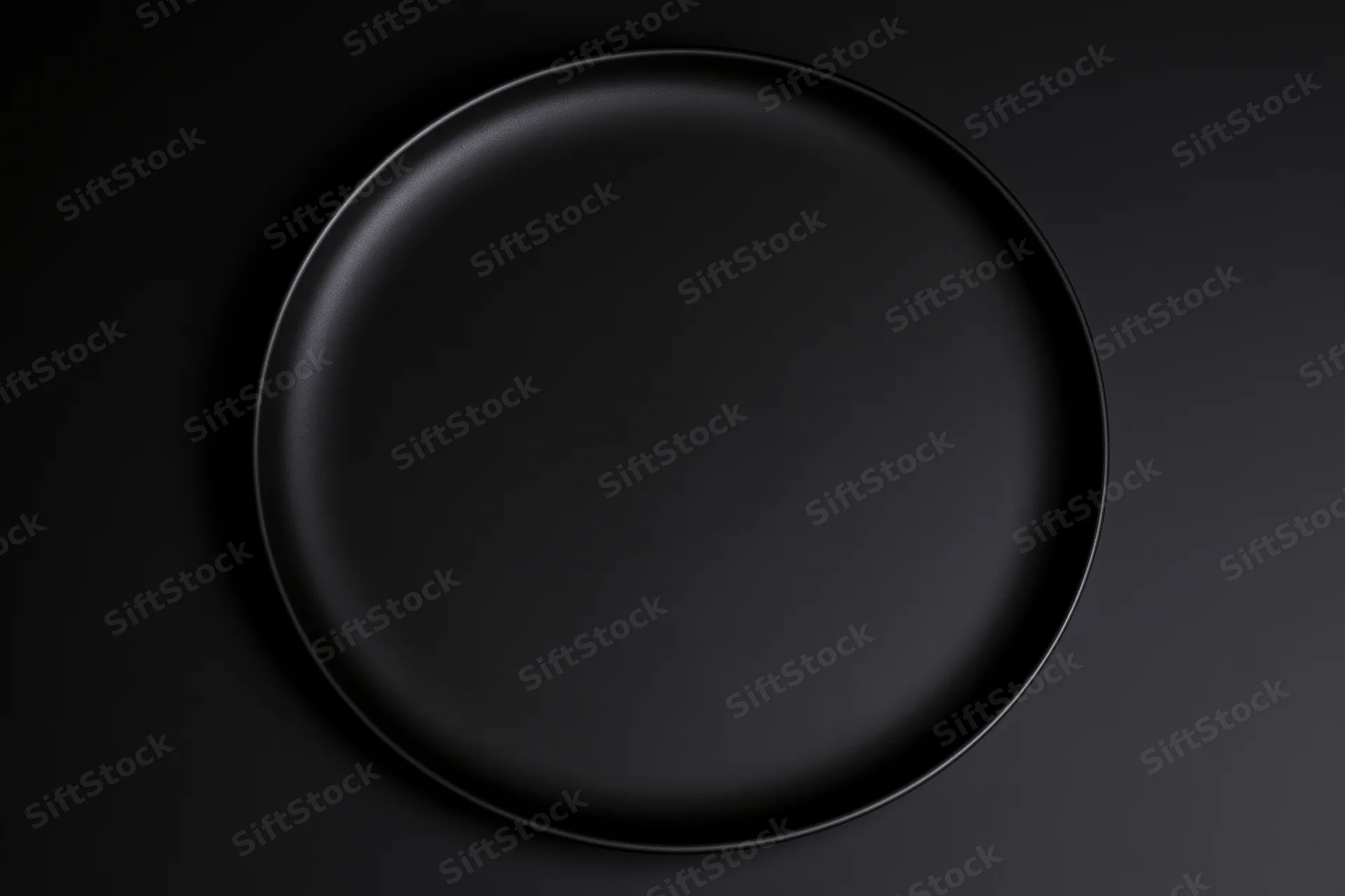 Matte black ceramic dinner plate centered on dark surface