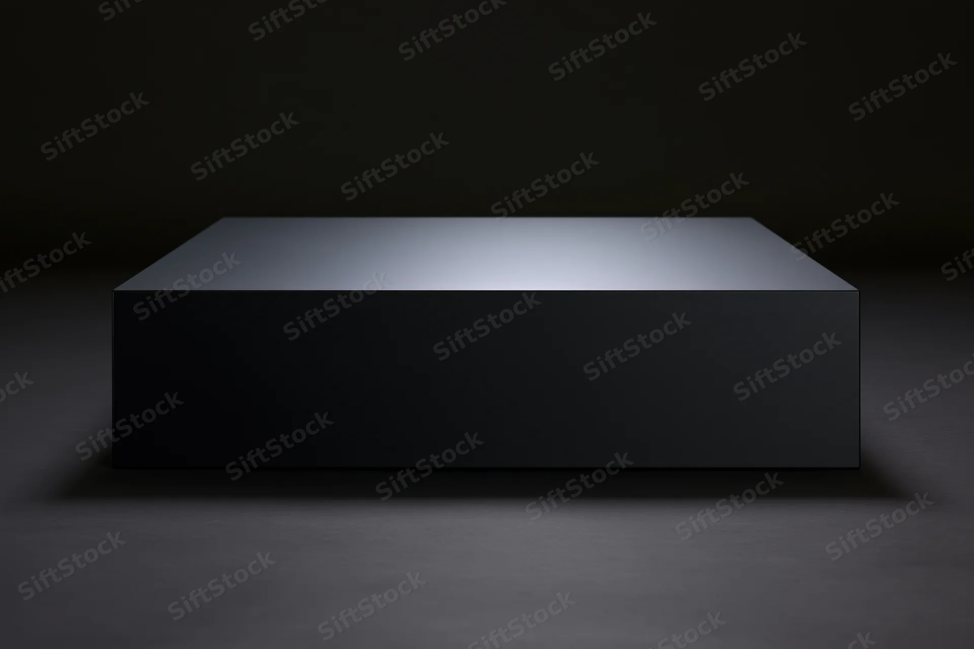 Matte black rectangular pedestal on dark floor under spotlight