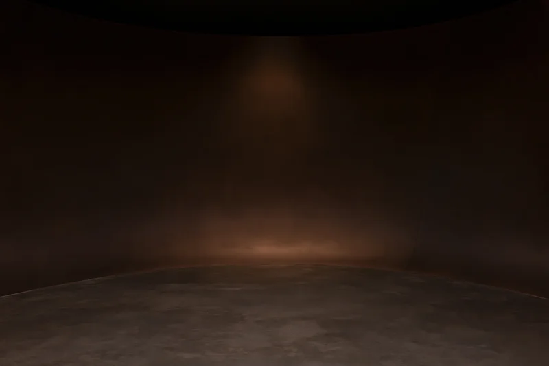 Empty curved studio interior with seamless wall-to-floor transition and spotlight lighting