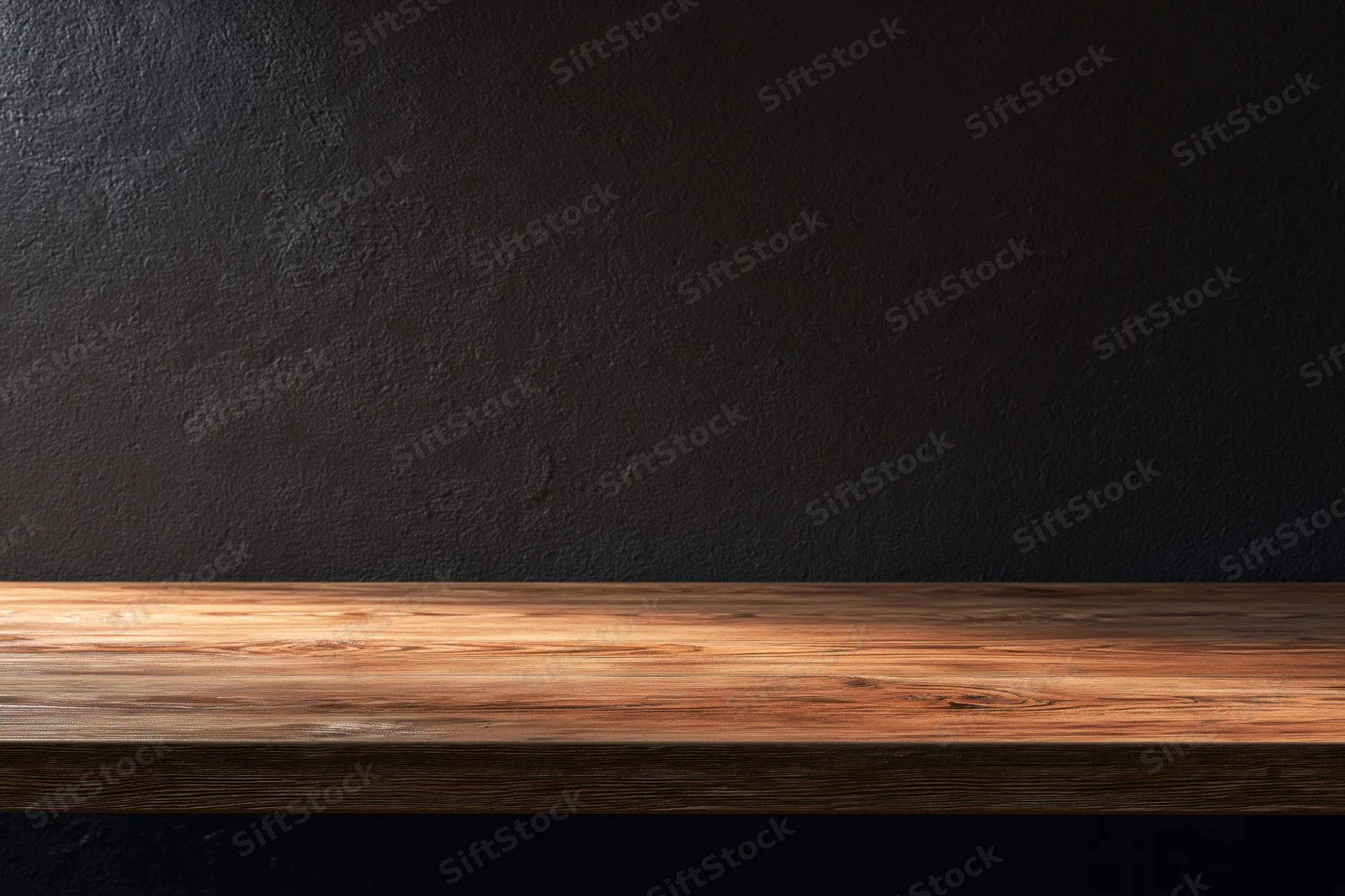 Empty wooden tabletop against dark textured plaster wall with copyspace for product display