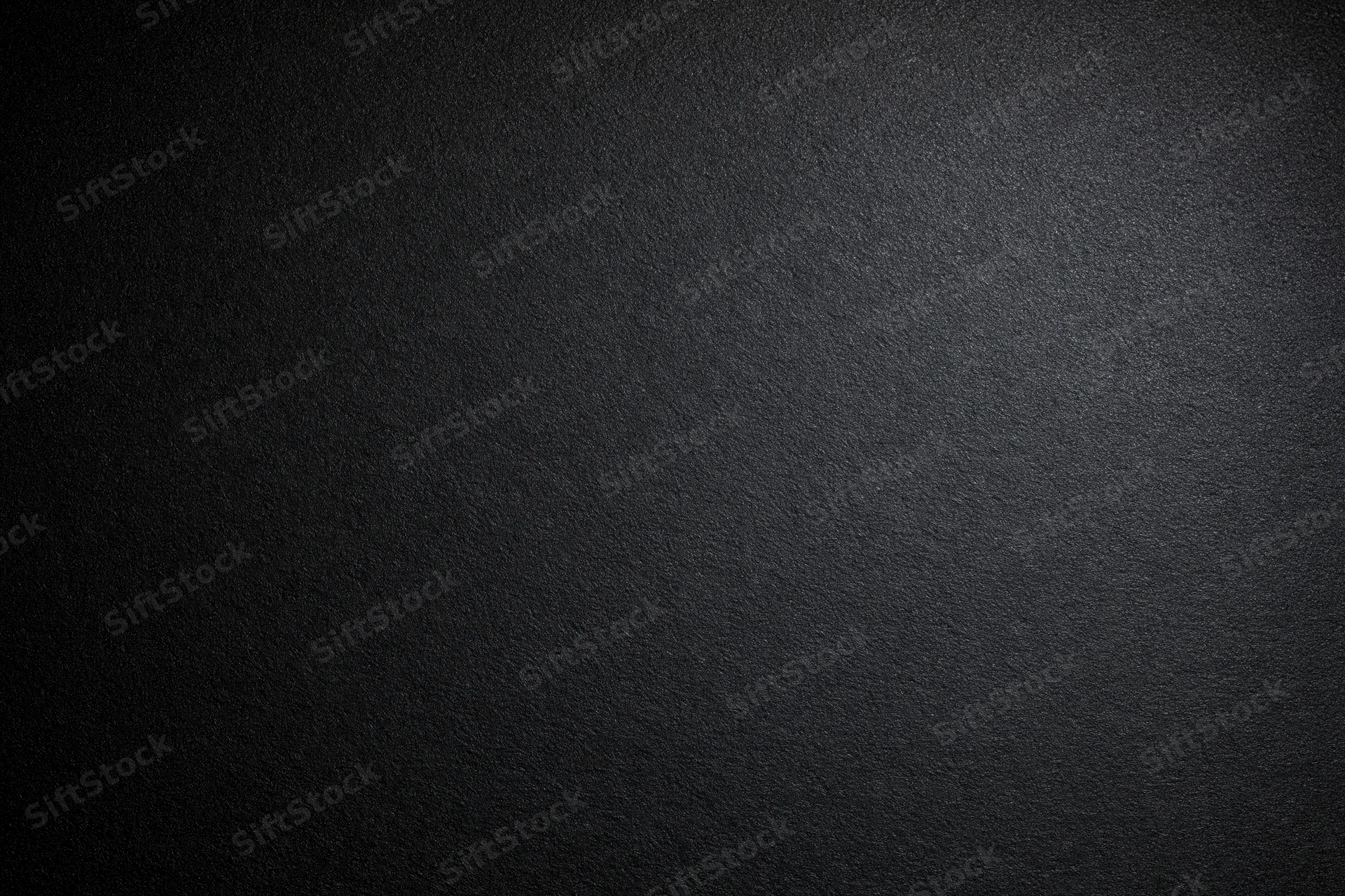 Dark charcoal textured surface filling the frame as a seamless background