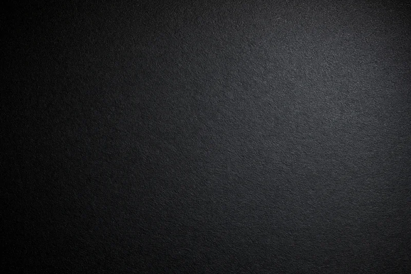 Dark charcoal textured surface filling the frame as a seamless background