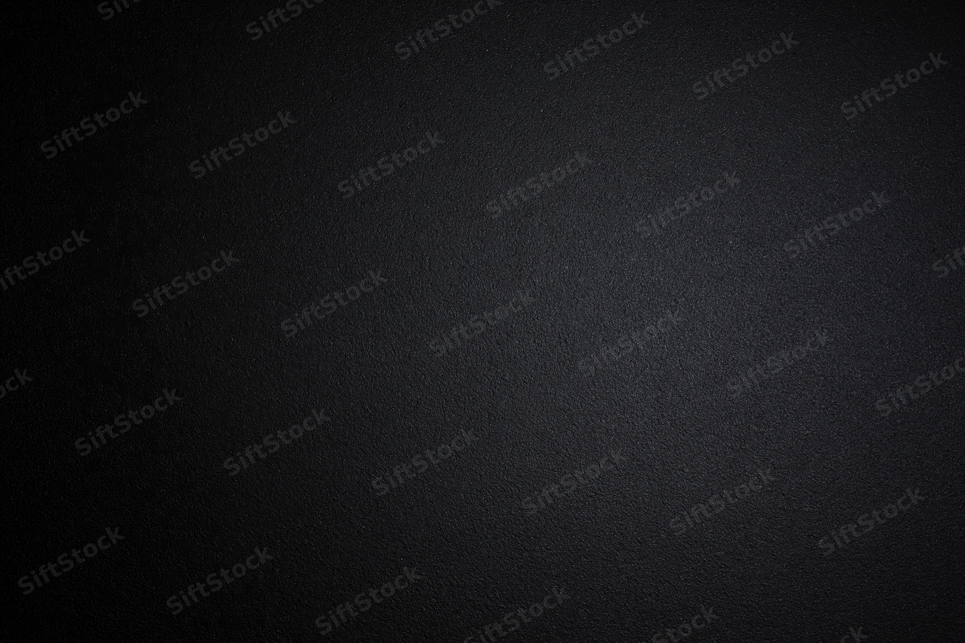 Dark charcoal textured matte surface filling the frame