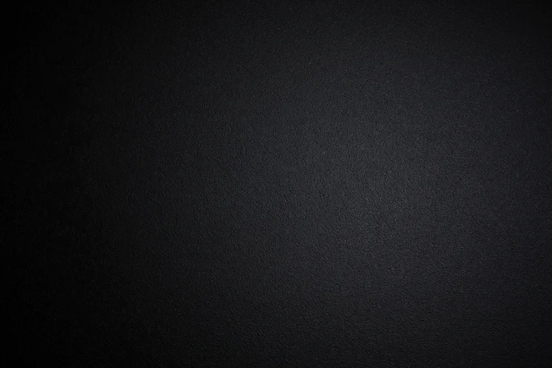 Dark charcoal textured matte surface filling the frame