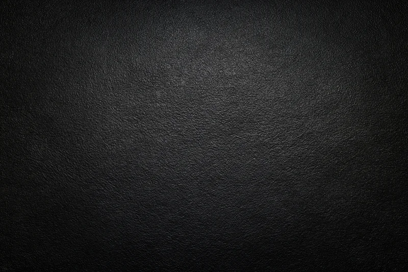 Dark charcoal textured leather surface filling the frame
