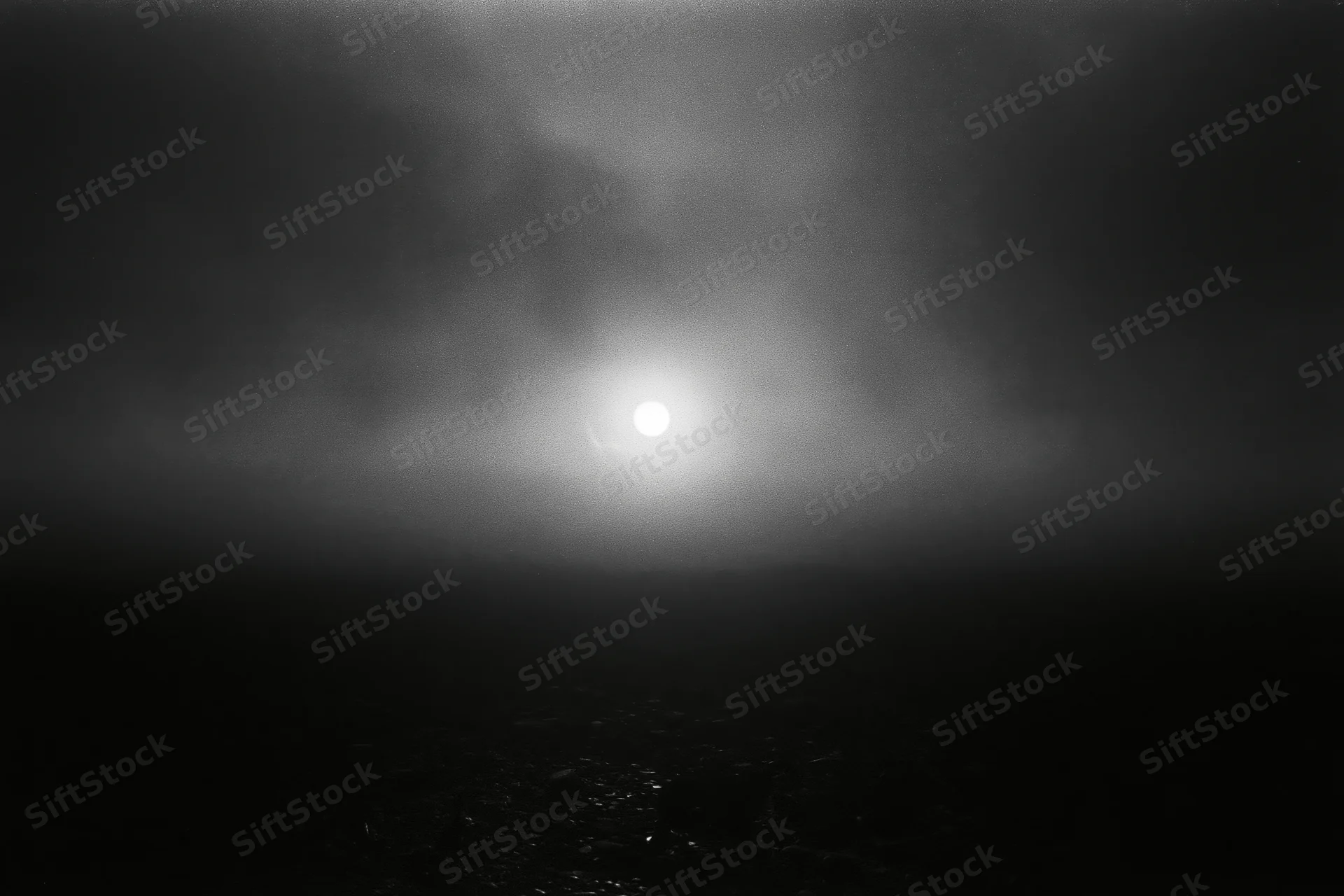 Full moon glowing through thick storm clouds over dark water surface