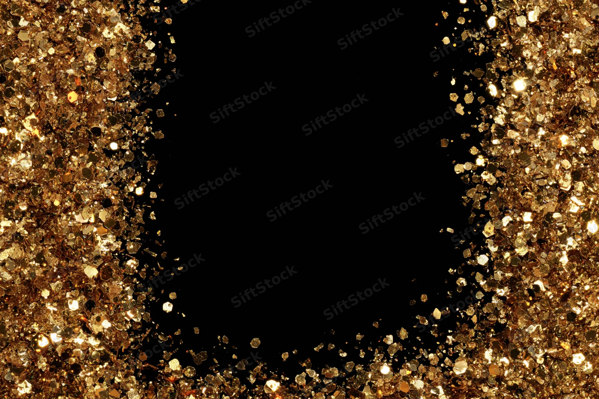 Gold glitter particles forming a sparkling frame around a black copyspace
