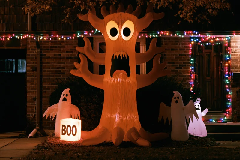 Inflatable halloween decorations glowing in front yard at night