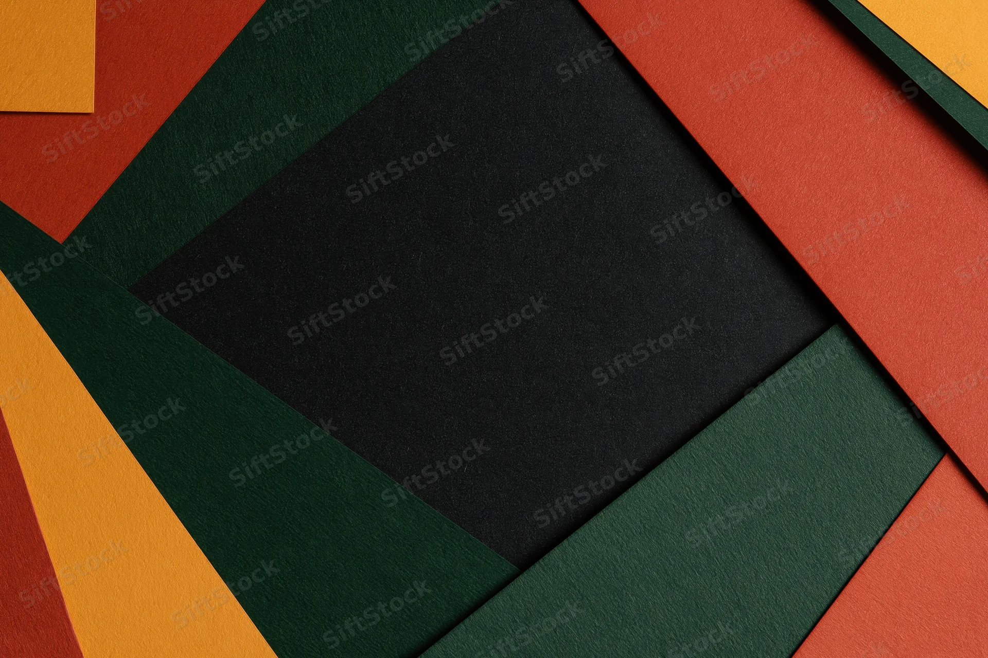 Layered geometric paper sheets arranged in abstract pattern with central copyspace