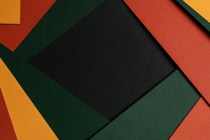 Layered geometric paper sheets arranged in abstract pattern with central copyspace