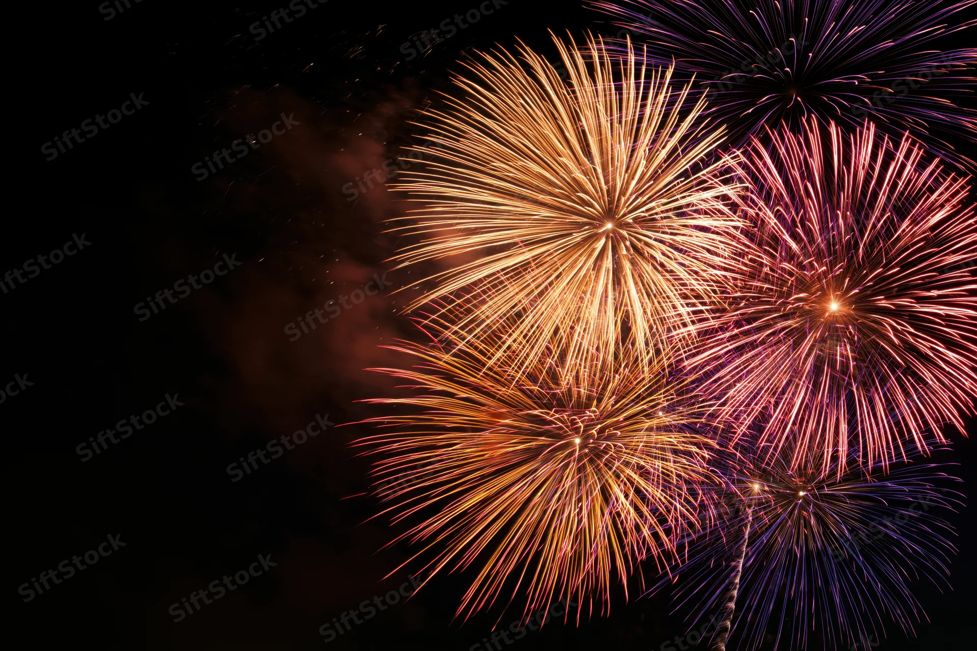 Fireworks bursting in the night sky during a celebration event