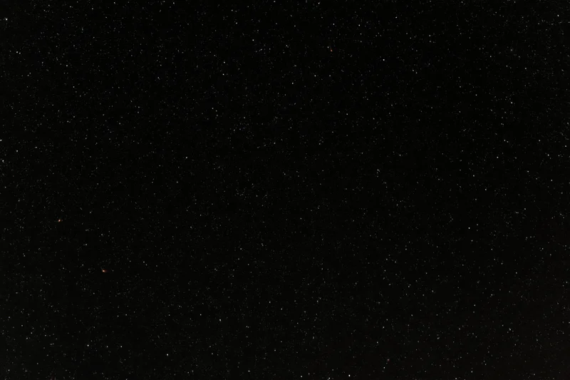 Night sky filled with scattered stars against dark background