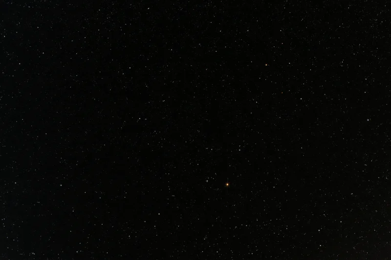 Night sky filled with scattered stars against dark background