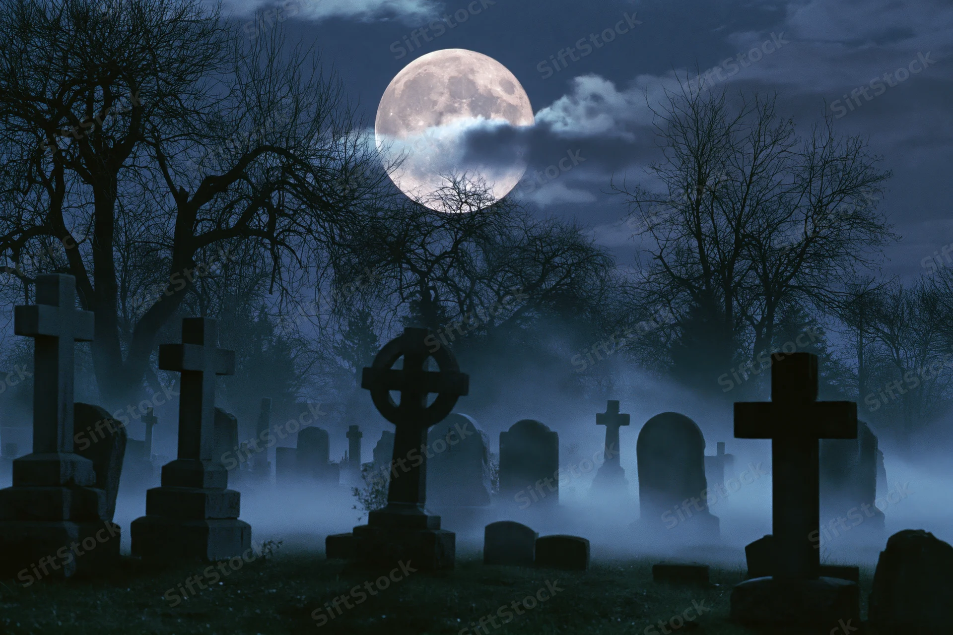 Old cemetery at night with stone crosses and tombstones under a full moon, surrounded by fog and bare trees