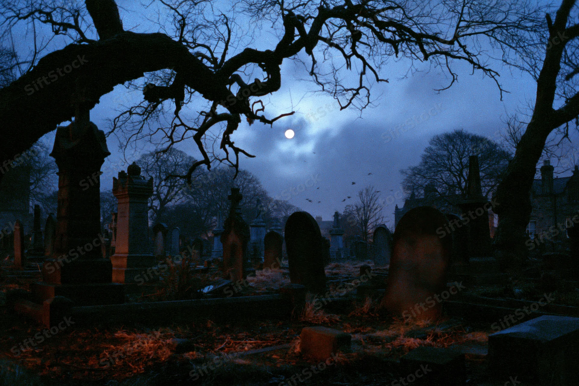 Old graveyard at night with weathered stone tombstones and bare trees under a full moon