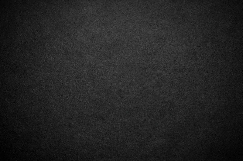 Dark charcoal textured surface filling the frame
