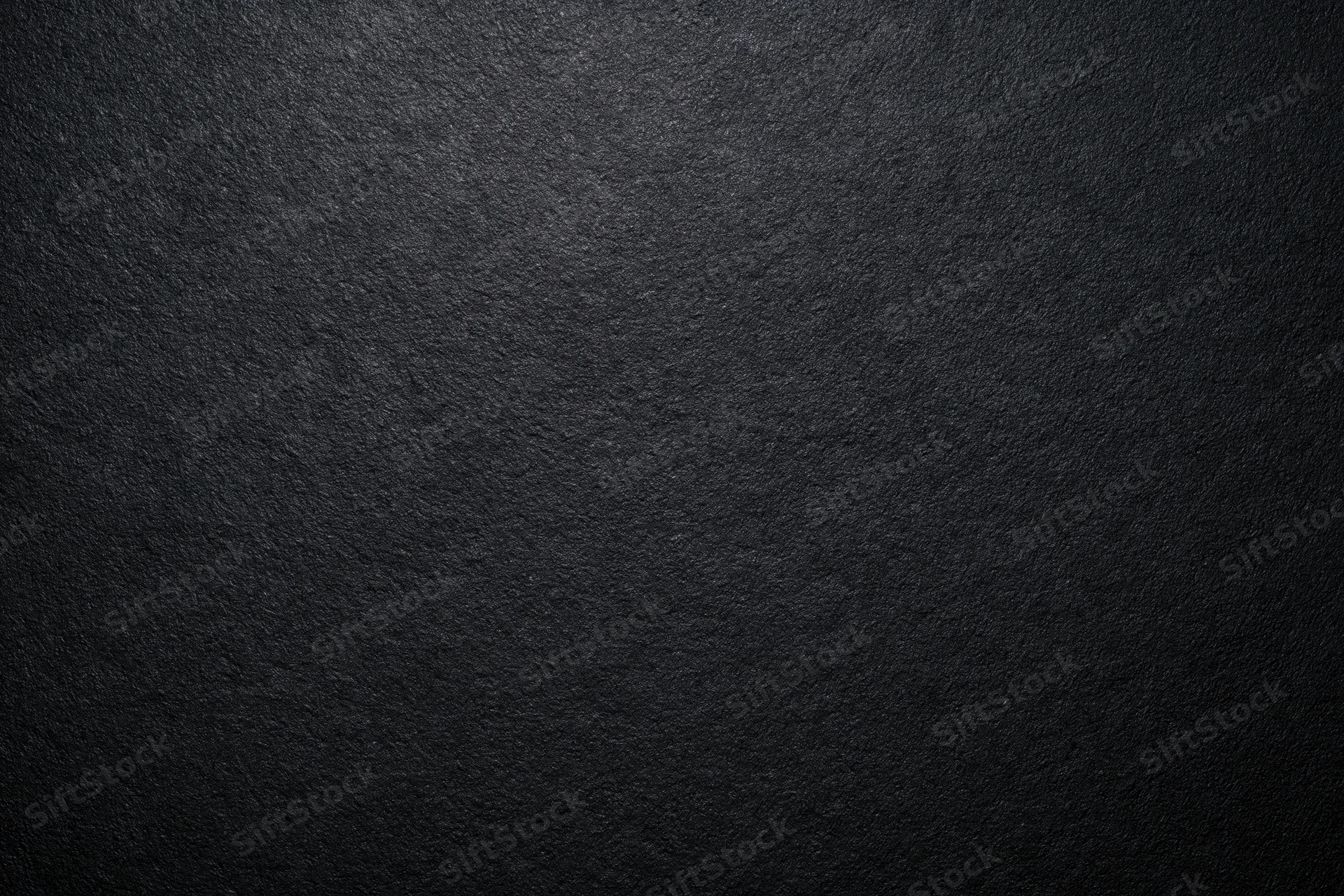 Dark charcoal textured surface filling the frame
