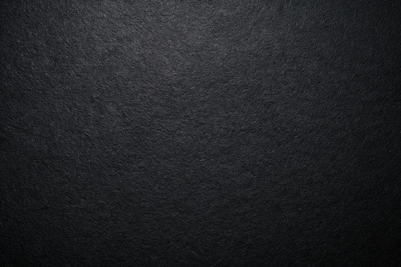 Dark charcoal textured surface filling the frame