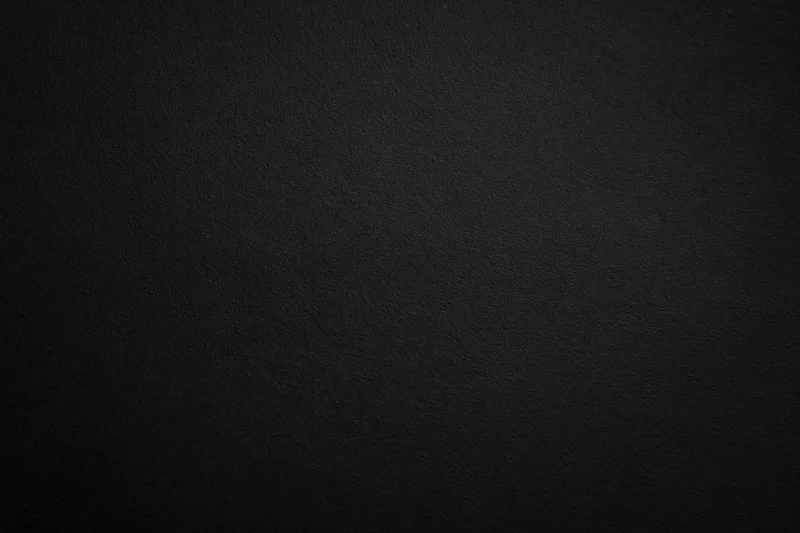 Dark charcoal textured surface filling the frame