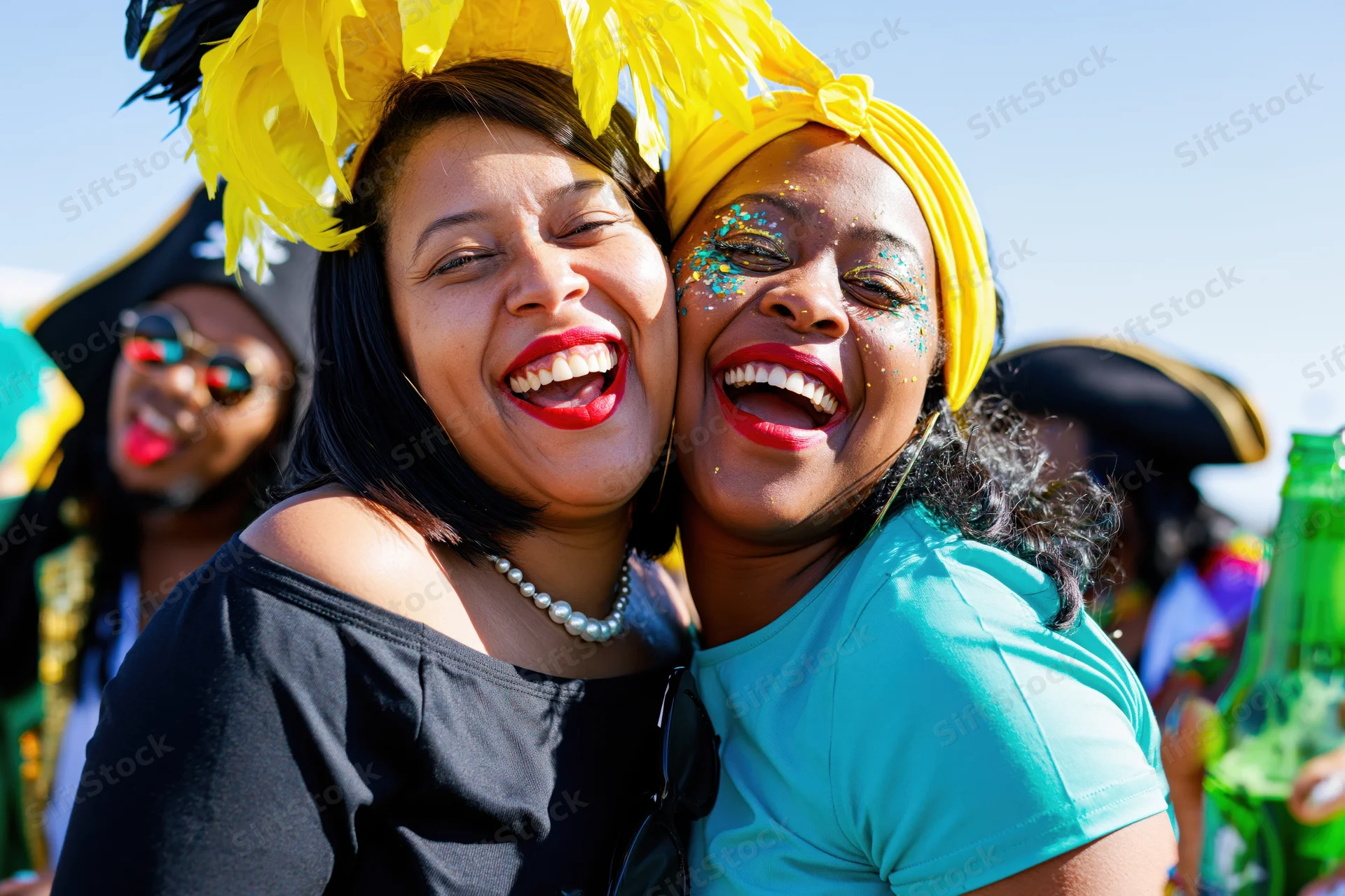 Two black brazilian women laughing together at a carnival festival outdoors