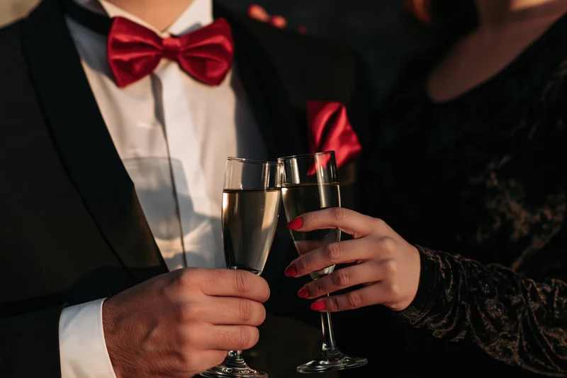Couple toasting with champagne flutes at a formal evening event