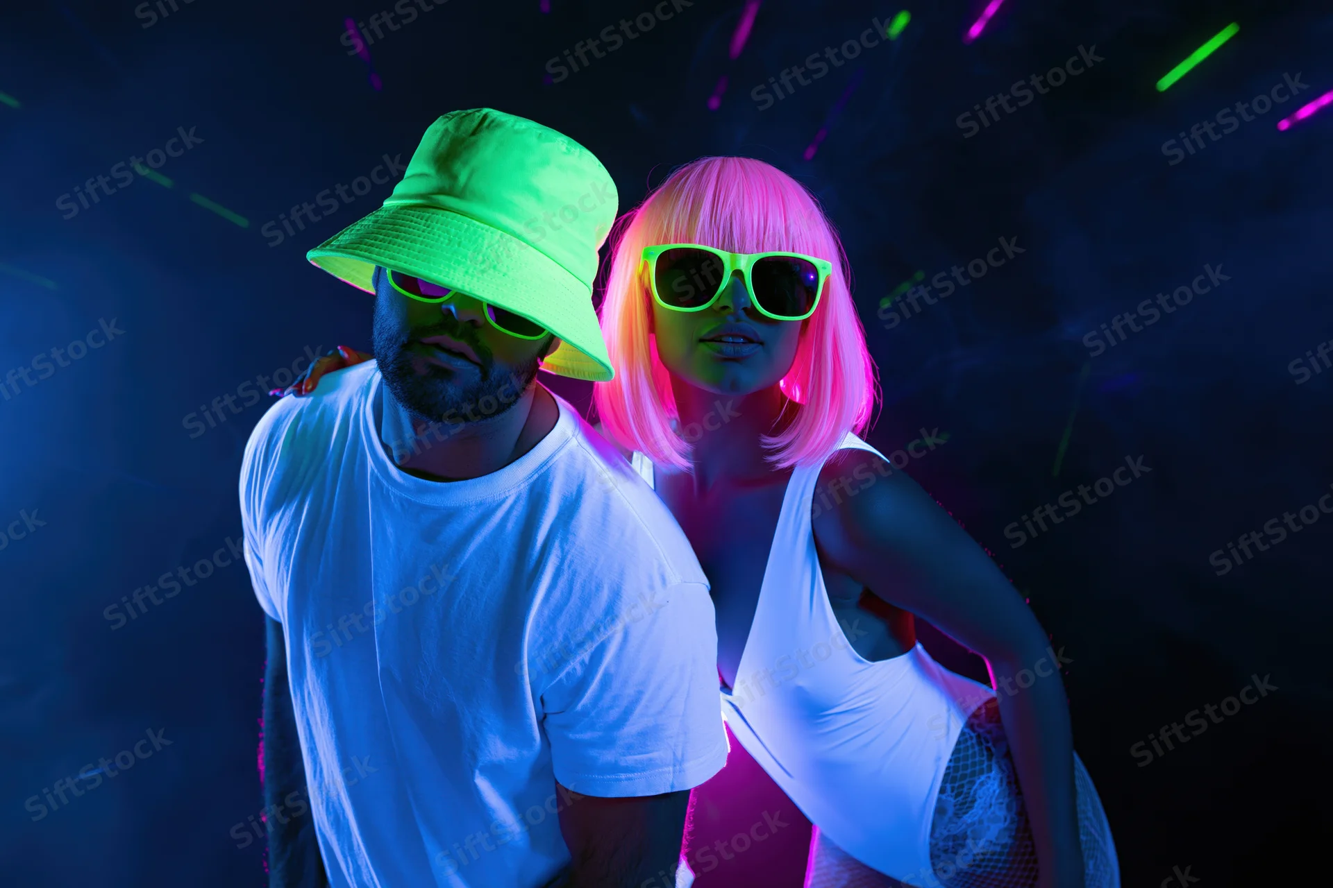 Couple posing together under uv blacklight in a nightclub