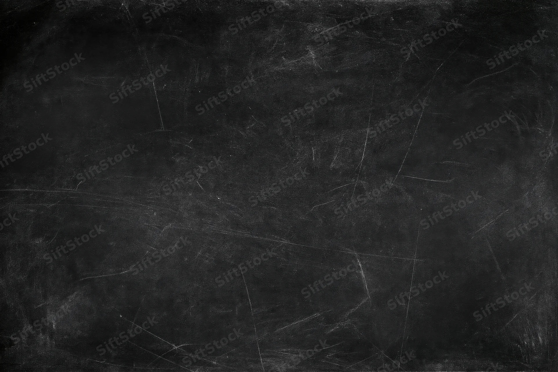 Worn blackboard surface with faint chalk smears and scratches, showing texture and residue from use