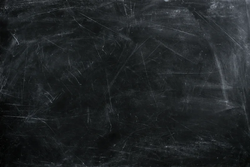 Worn blackboard surface with faint chalk smears and scratches