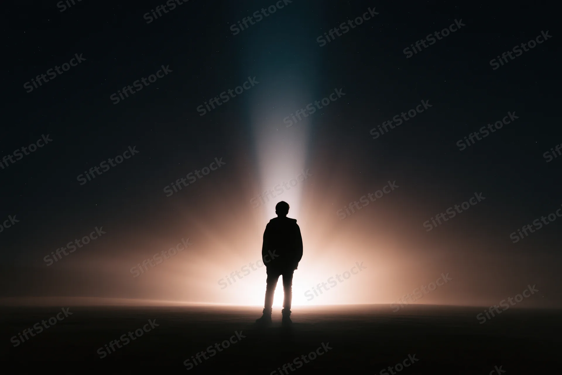Silhouette of a person standing alone outdoors at night facing a glowing horizon under a starry sky