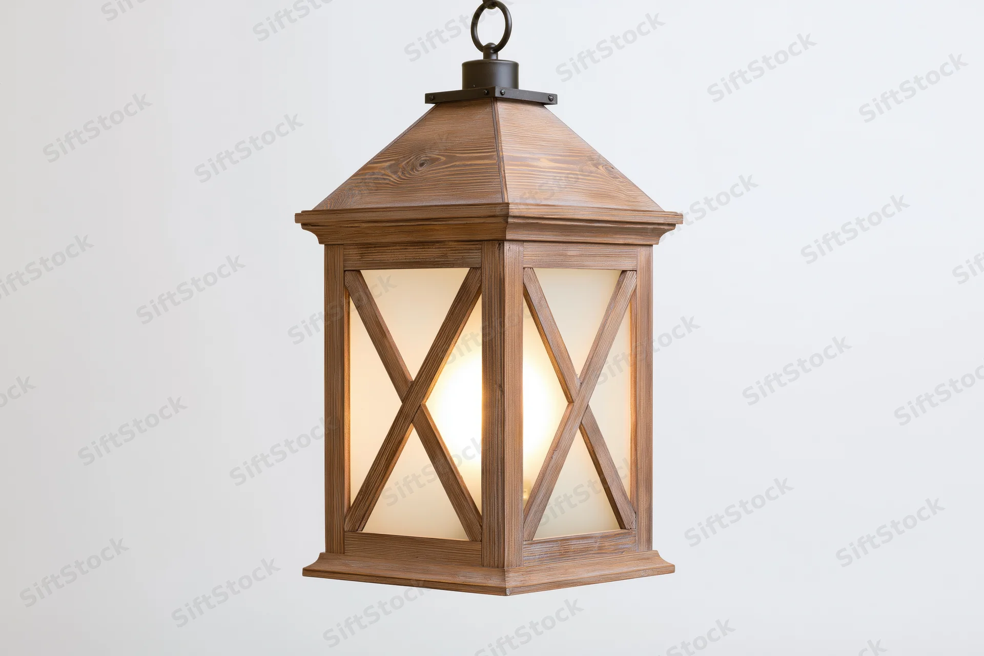 Rustic wooden lantern with x-cross glass panels hanging against white background