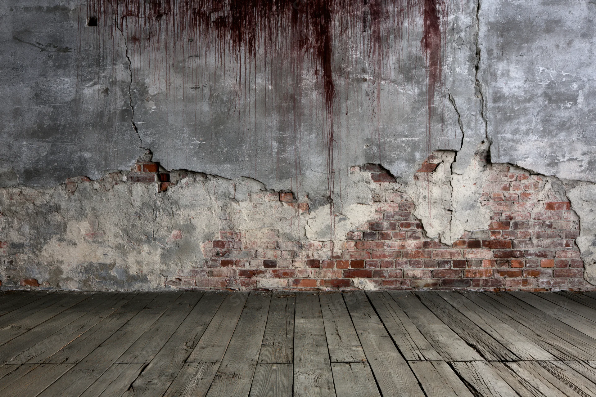Abandoned room with damaged concrete wall exposing brick and stained with red drips, wooden floor