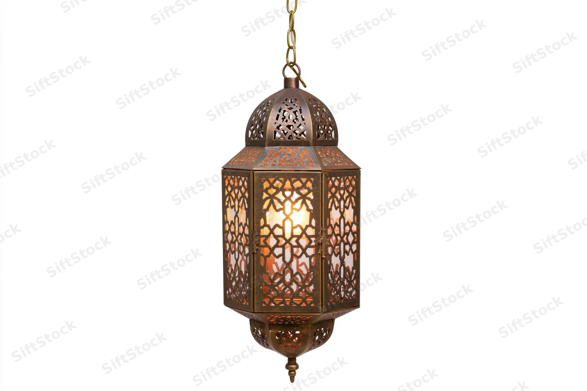 Antique moroccan lantern hanging from brass chain with intricate cutout patterns glowing warmly against white background
