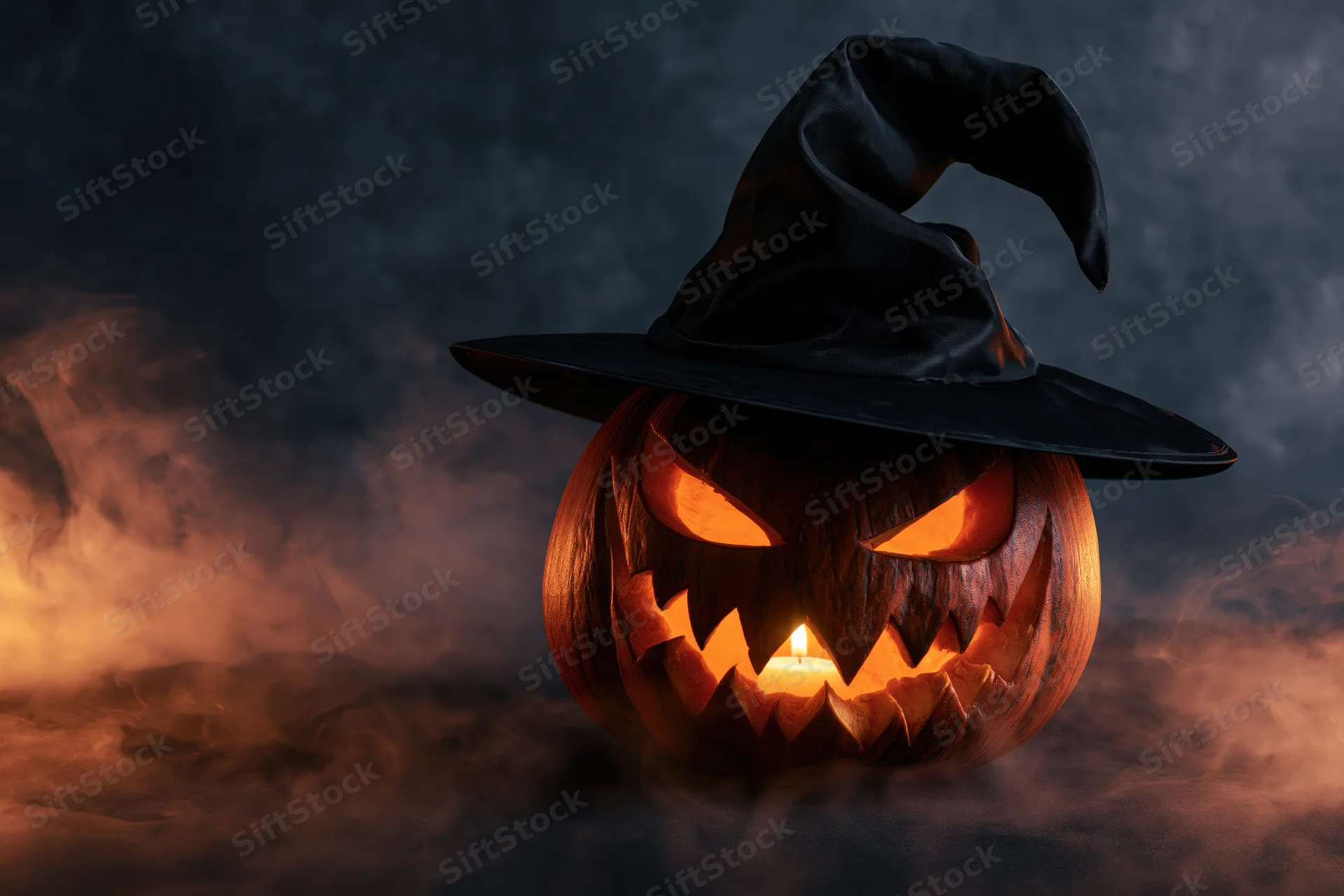 Carved jack-o-lantern with witch hat glowing in smoke at night
