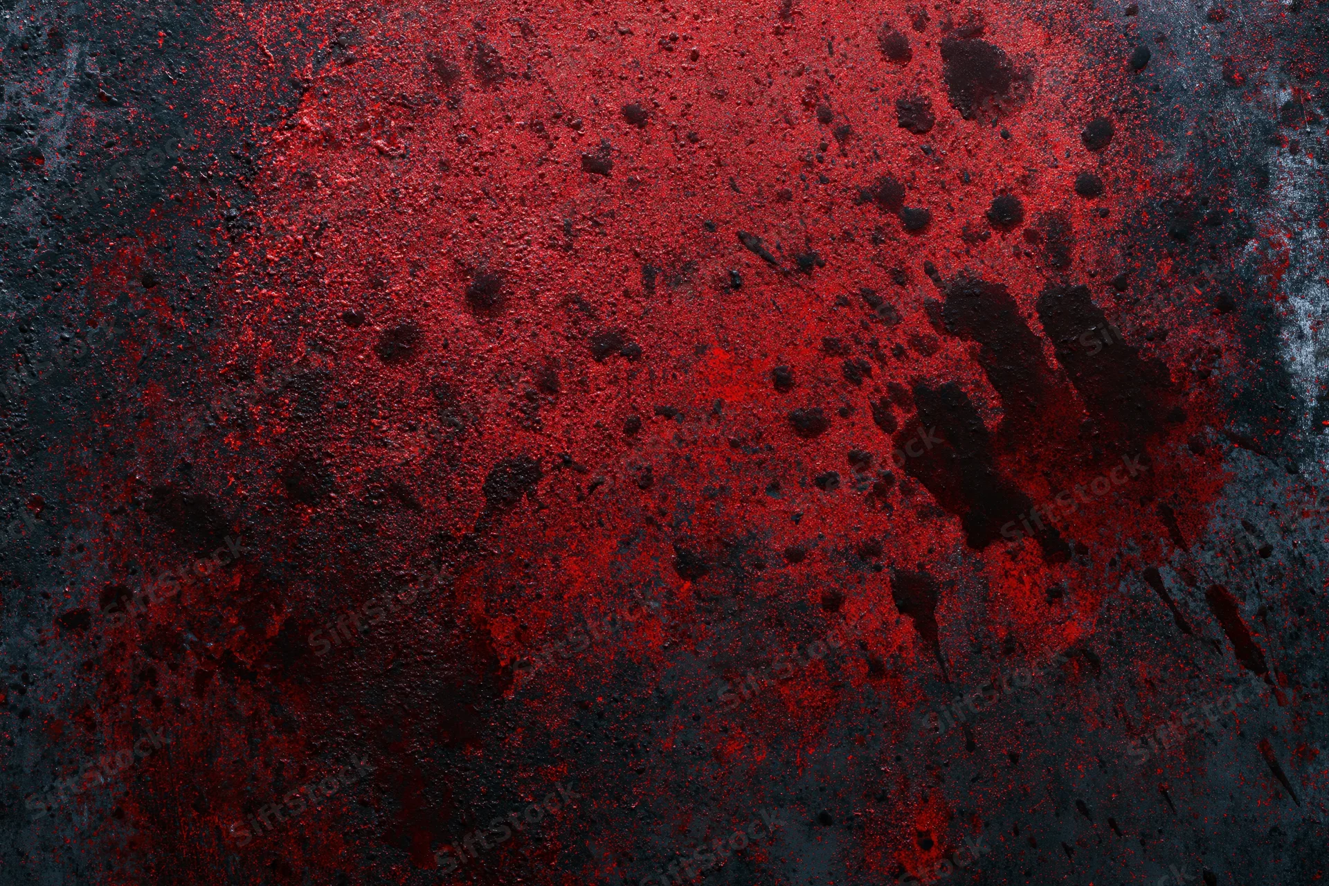 Red handprint and splatters on dark textured surface