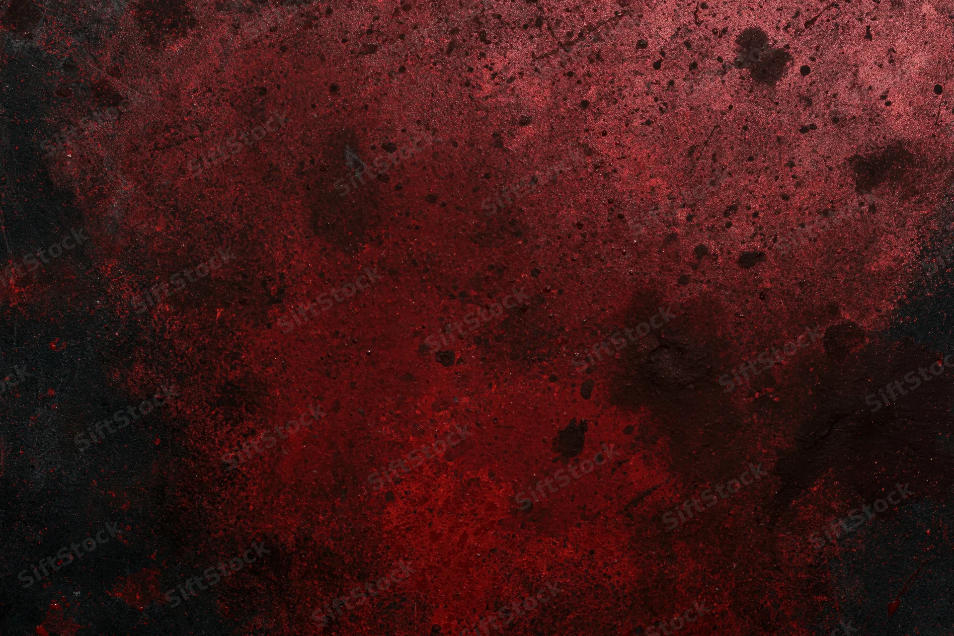 Abstract red and black splattered texture on rough industrial surface