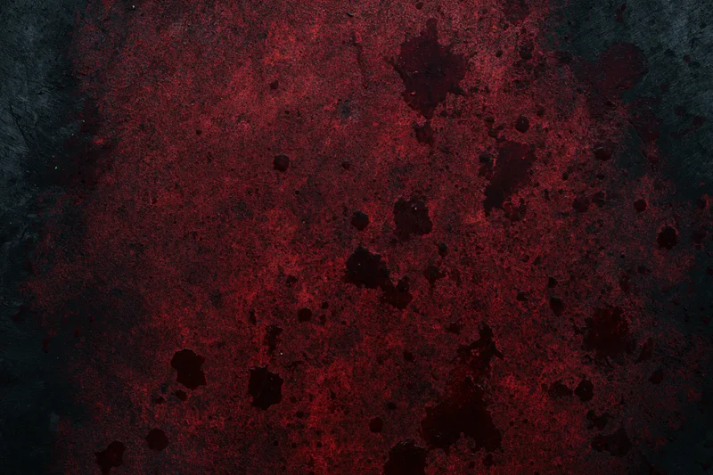 Abstract red splatters on a dark rough surface