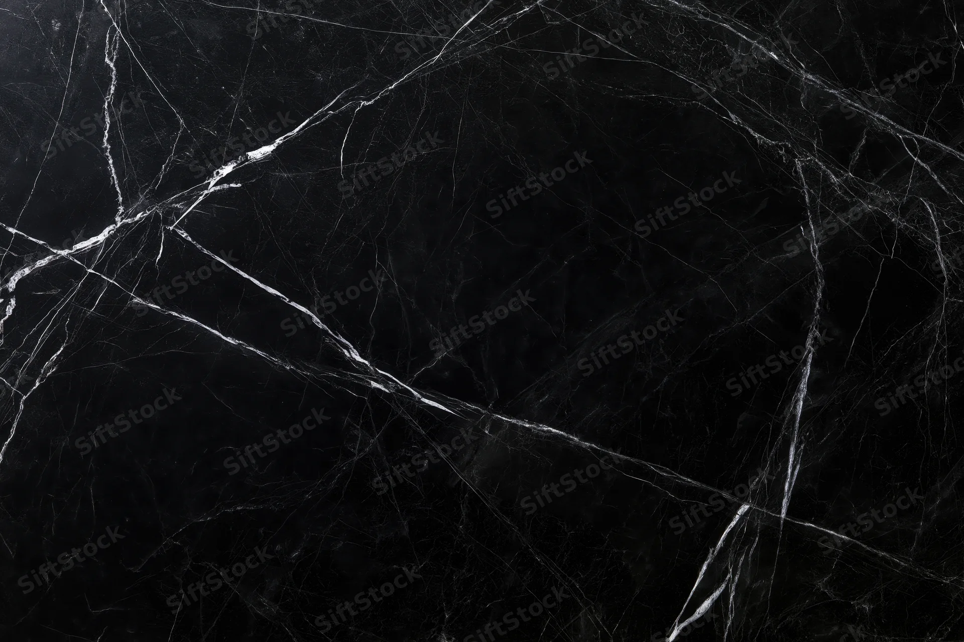 Close-up of polished black marble surface with white veining for interior design