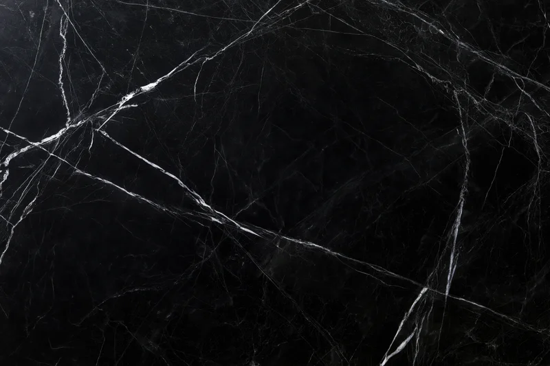 Close-up of polished black marble surface with white veining for interior design