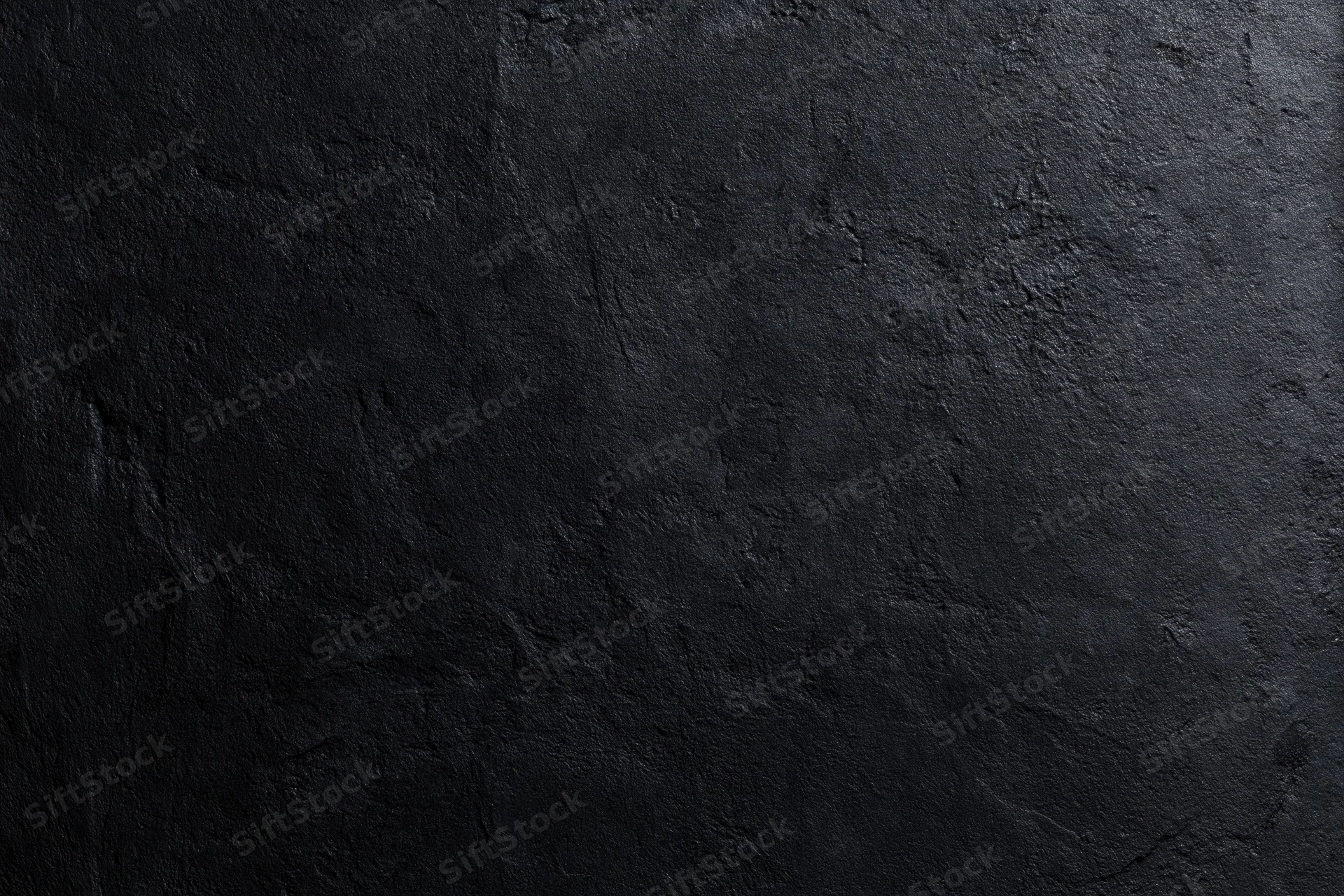 Close-up of rough dark concrete wall surface