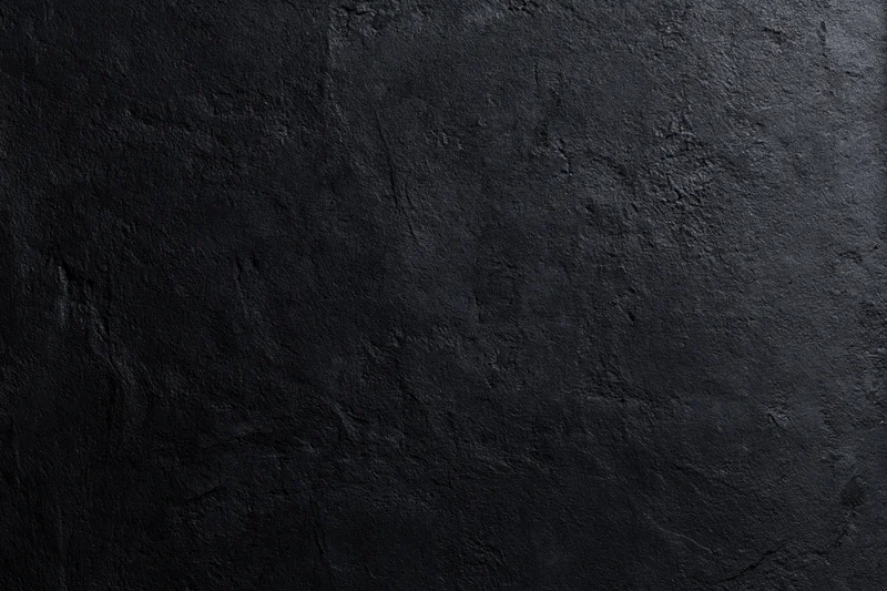 Close-up of rough dark concrete wall surface